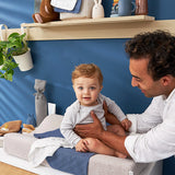 Baby sitting on the Meyco changing pad cover teddy greige color