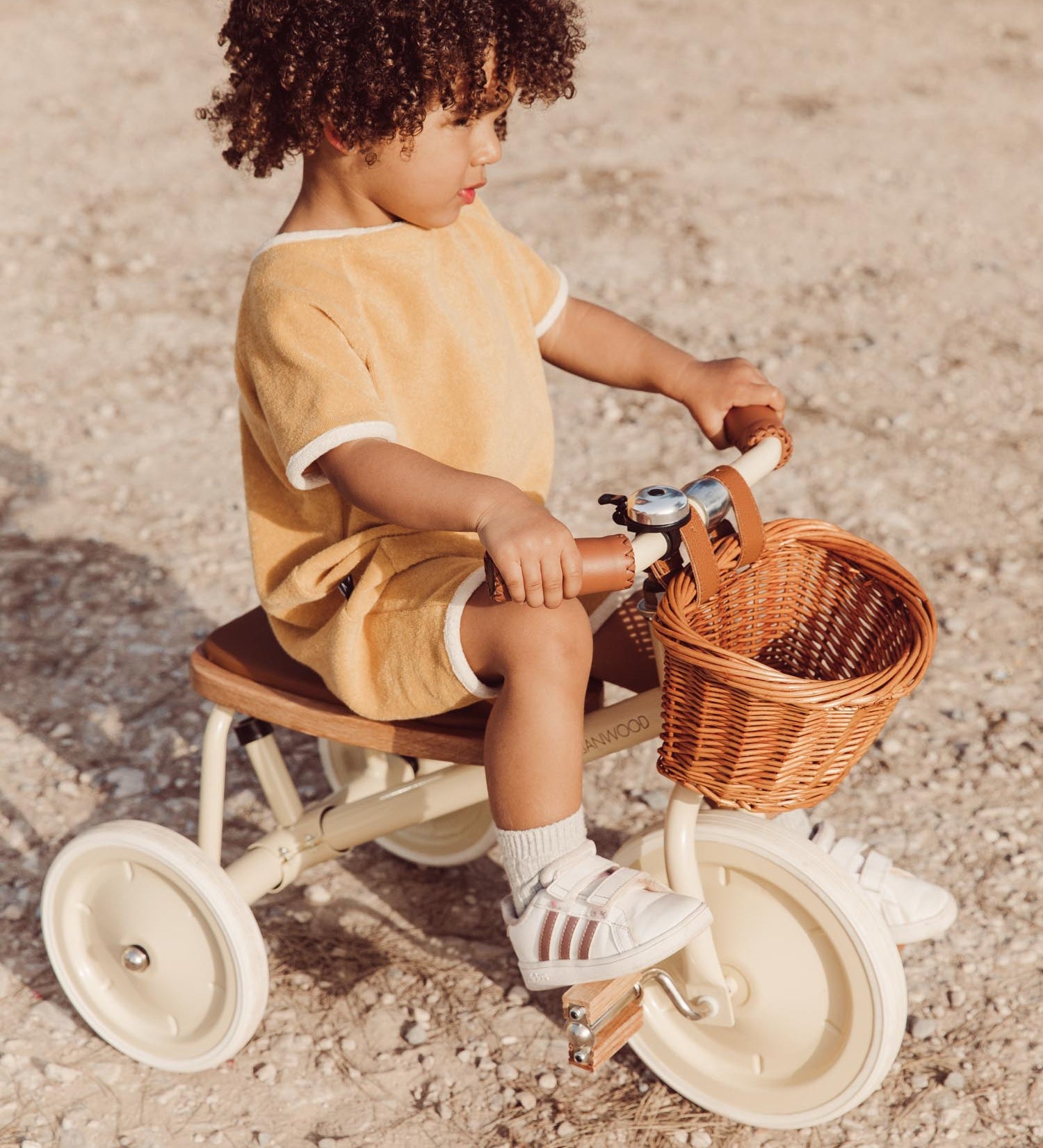 Boy riding the Banwood Trike Cream