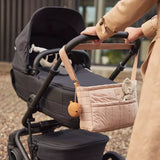 Mother walking a buggy with the Jollein Buggy Organizer Puffed Biscuit