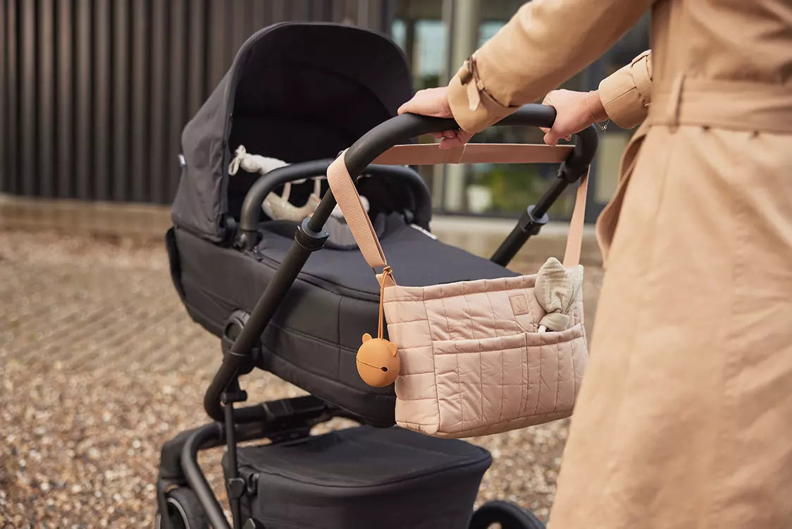 Mother walking a buggy with the Jollein Buggy Organizer Puffed Biscuit