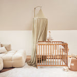 Jollein Canopy olive green in a living room above a play pen