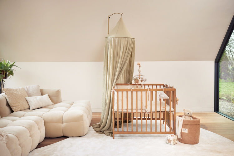 Jollein Canopy olive green in a living room above a play pen