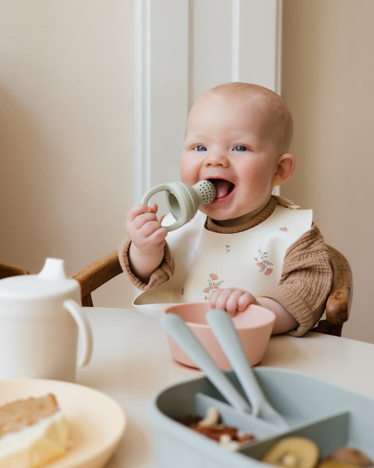Baby with the Mushie Silicone Fresh Food Feeder (2pack) Sage
