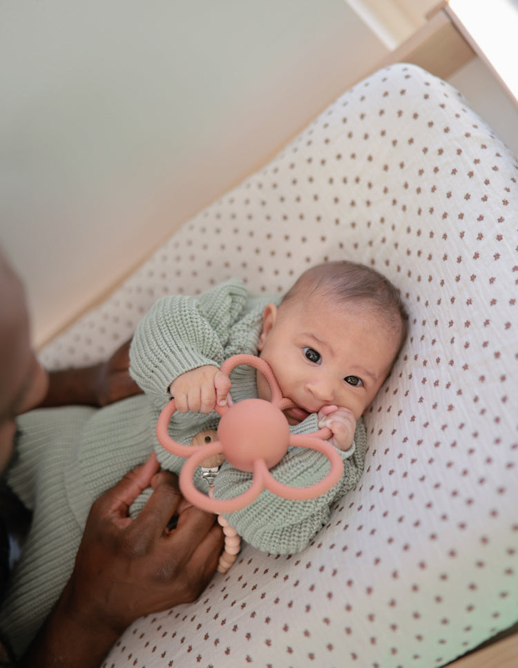 Baby with the Mushie Rattle Teether Daisy