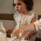 Snug | Organic cotton dungarees with ruffle