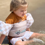 Kid with Swim Essentials Puddle Jumper Sand Check Retro Car