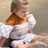 Kid with Swim Essentials Puddle Jumper Sand Check Retro Car