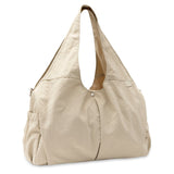 Jollein Urban diaper bag in Warm Sand, angled view with carry handles