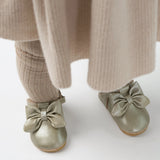 Donsje Celie baby shoes in Champagne Metallic Leather, worn with a beige outfit