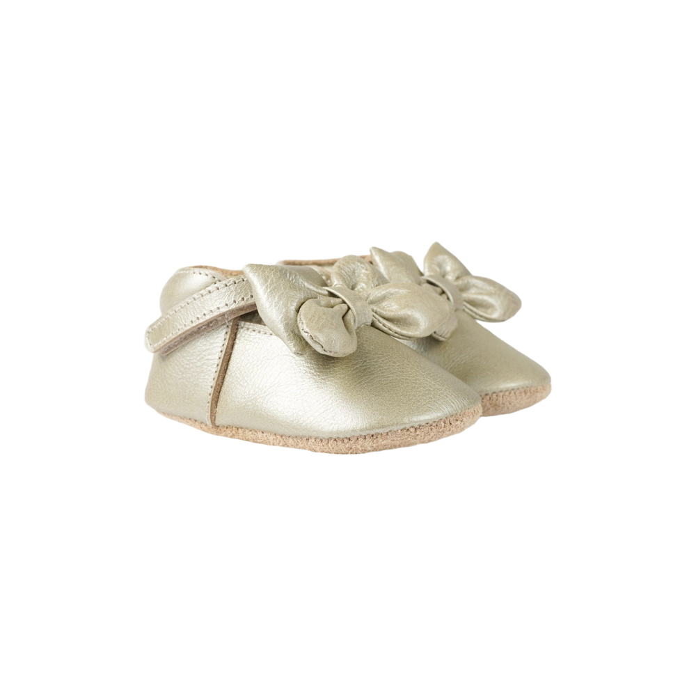 Donsje Celie baby shoes in Champagne Metallic Leather, with bow details, angled front view