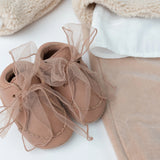 Donsje Lonny baby sneakers in Rose Dawn Classic Leather, with chiffon bows, styled product photograph