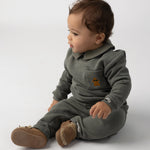 Donsje Nolin baby loafers in Truffle Nubuck, worn by a seated child
