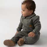 Donsje Nolin baby loafers in Truffle Nubuck, worn by a seated child
