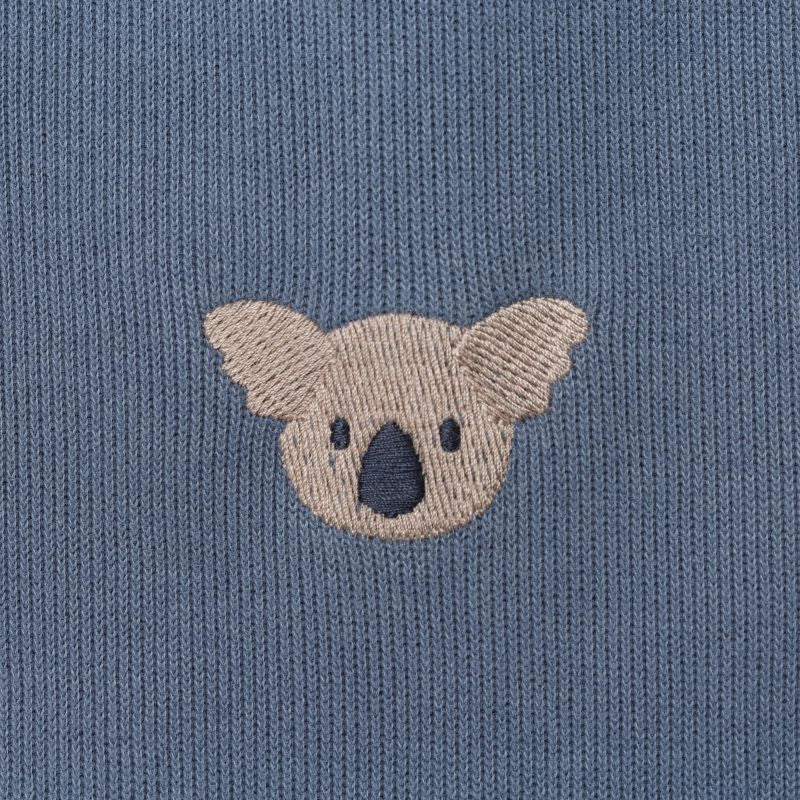 Donsje Phlyn Koalas onesie in Dark Spruce, close-up of an embroidered koala motif