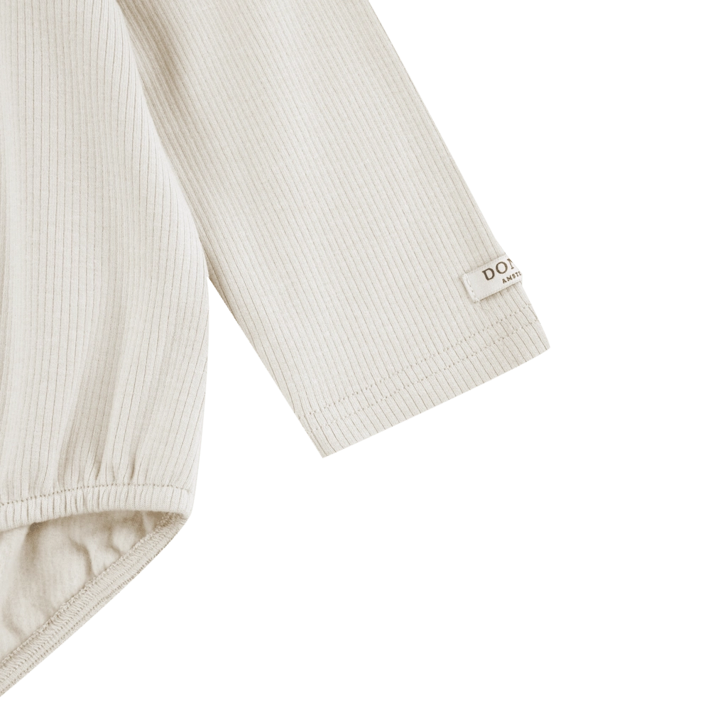 Donsje Fabien bodysuit in Birch, close-up of the sleeve and cuff