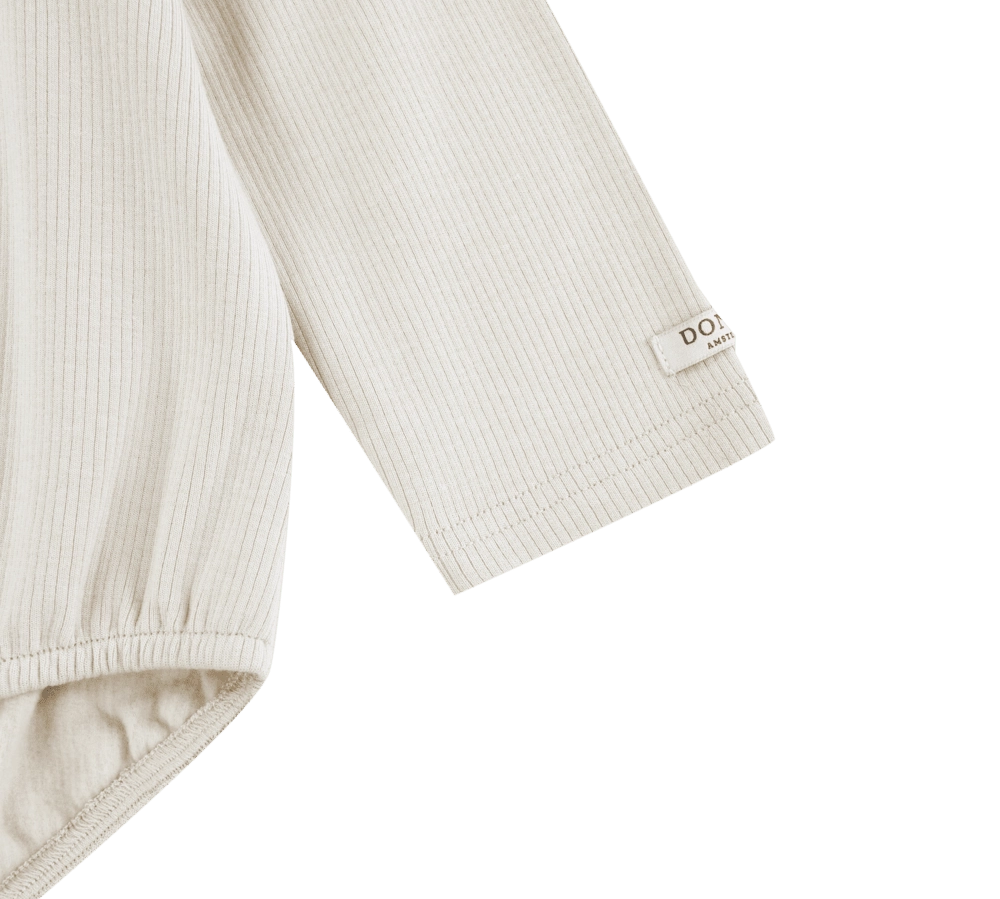 Donsje Fabien bodysuit in Birch, close-up of the sleeve and cuff