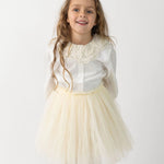 Donsje Kya skirt in Warm White, worn by a child with a white blouse