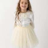 Donsje Kya skirt in Warm White, worn by a child with a white blouse