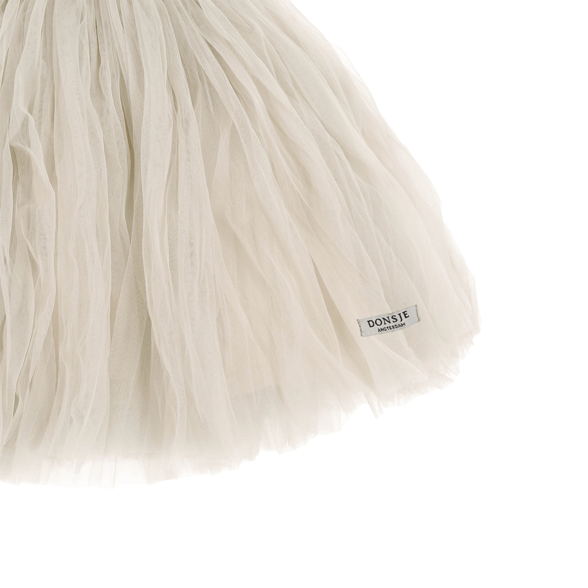 Donsje Kya skirt in Warm White, close-up of the fabric and brand label