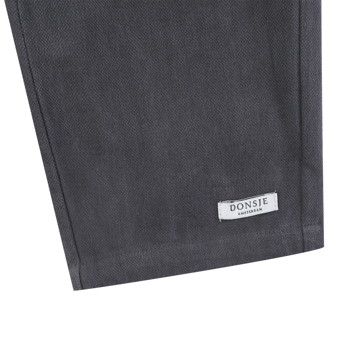 Donsje Kassim Koala trousers in Cloudy Grey, close-up of the hem and brand label
