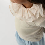 Donsje Florentien top in Birch, worn by a child, close-up of the collar