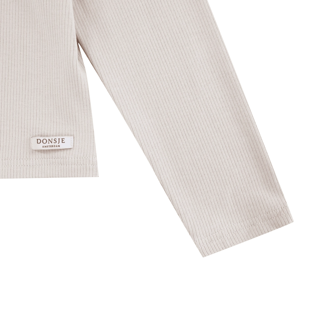 Donsje Florentien top in Birch, close-up of the sleeve and brand label