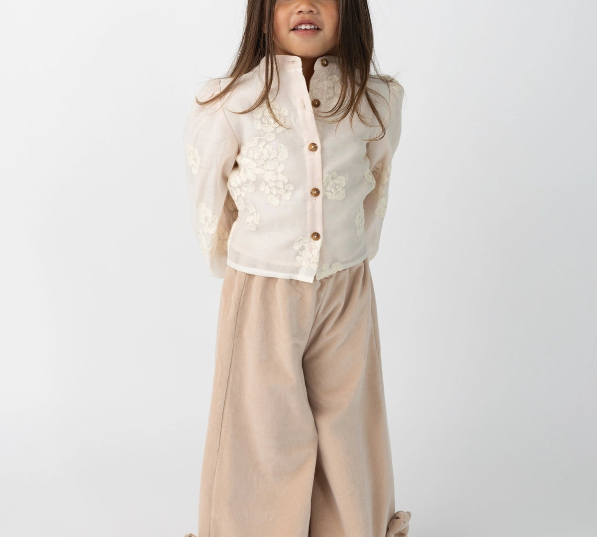 Donsje Nolien Bow trousers in Vintage Rose, worn by a child, front view