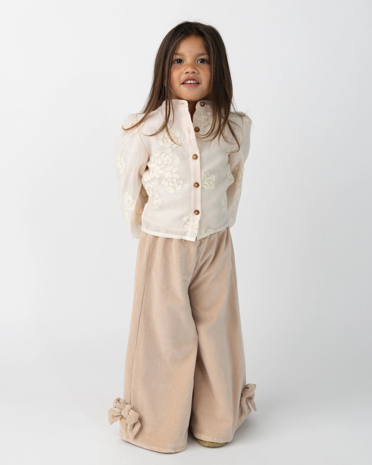Donsje Nolien Bow trousers in Vintage Rose, worn by a child, front view