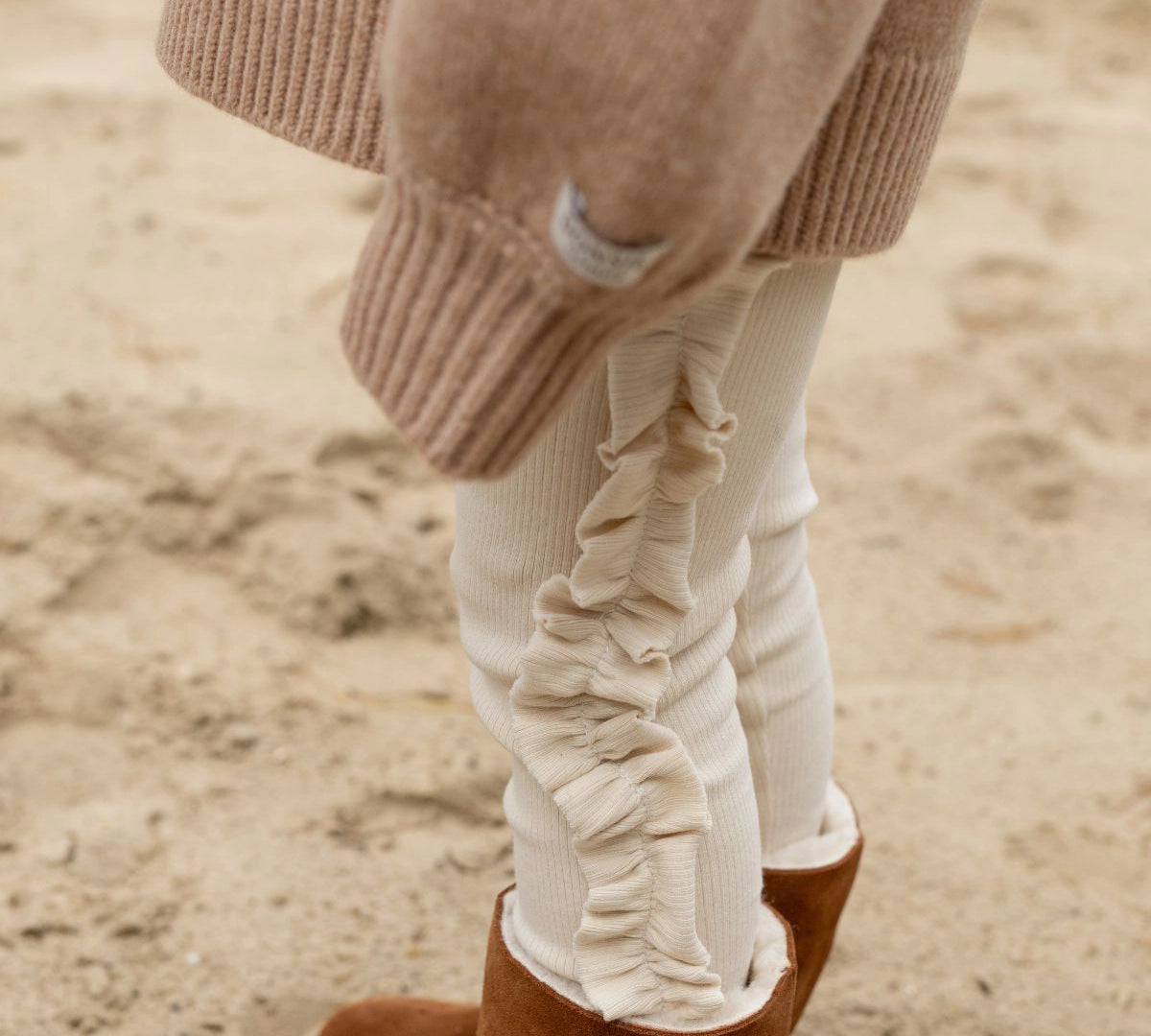 Donsje Audun leggings in Macaroon, worn by a child with brown boots