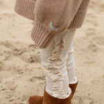 Donsje Audun leggings in Macaroon, worn by a child with brown boots