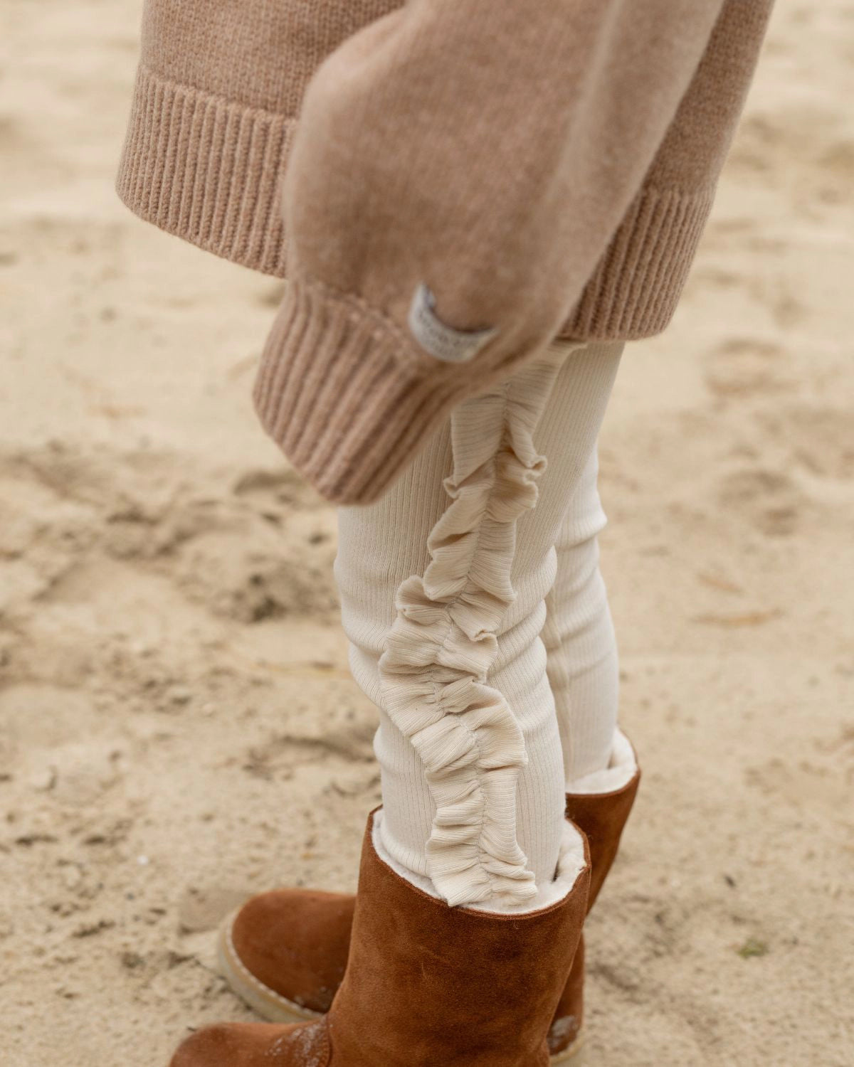 Donsje Audun leggings in Macaroon, worn by a child with brown boots