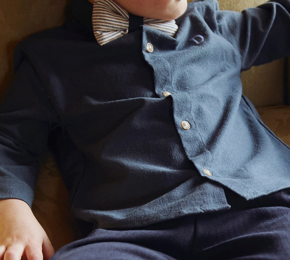 Donsje Chee shirt in Night Blue, worn by a seated child