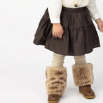 Donsje Azani skirt in Toffee, worn by a child with a cream cardigan and boots