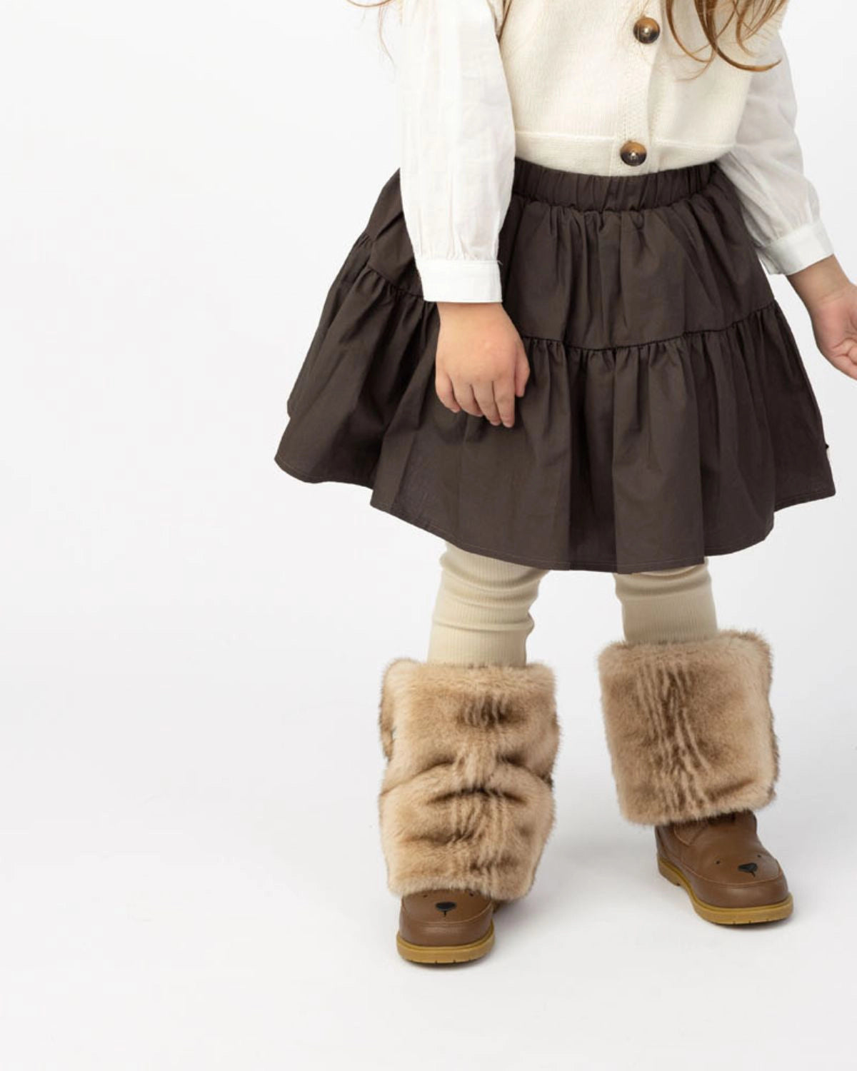 Donsje Azani skirt in Toffee, worn by a child with a cream cardigan and boots