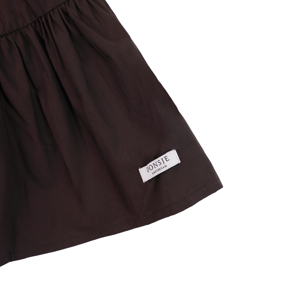 Donsje Azani skirt in Toffee, close-up of the hem and brand label
