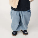 Donsje Dinotje trousers in Sky Blue, worn by a child, close-up of the trousers