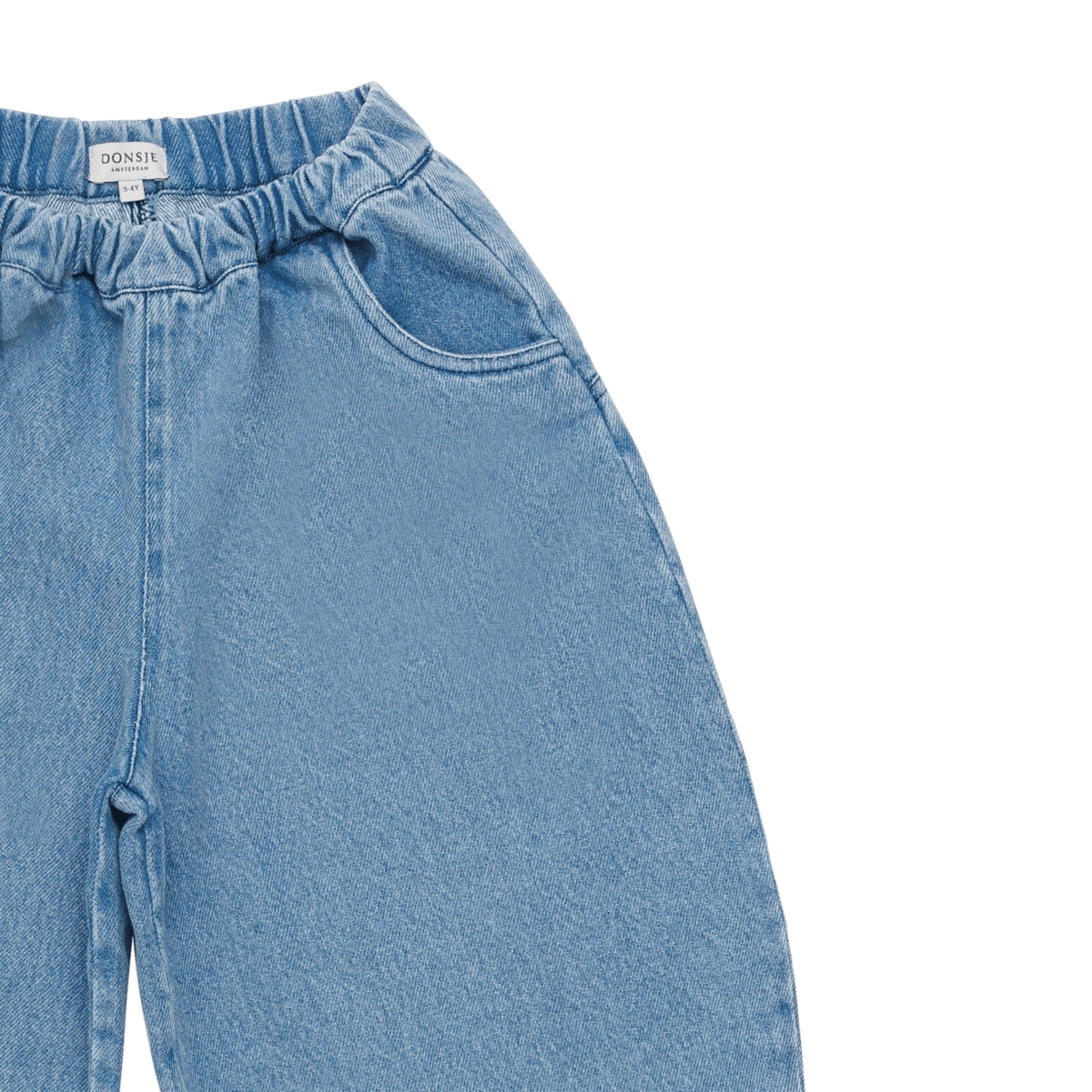 Donsje Dinotje trousers in Sky Blue, close-up of the waistband and front pockets