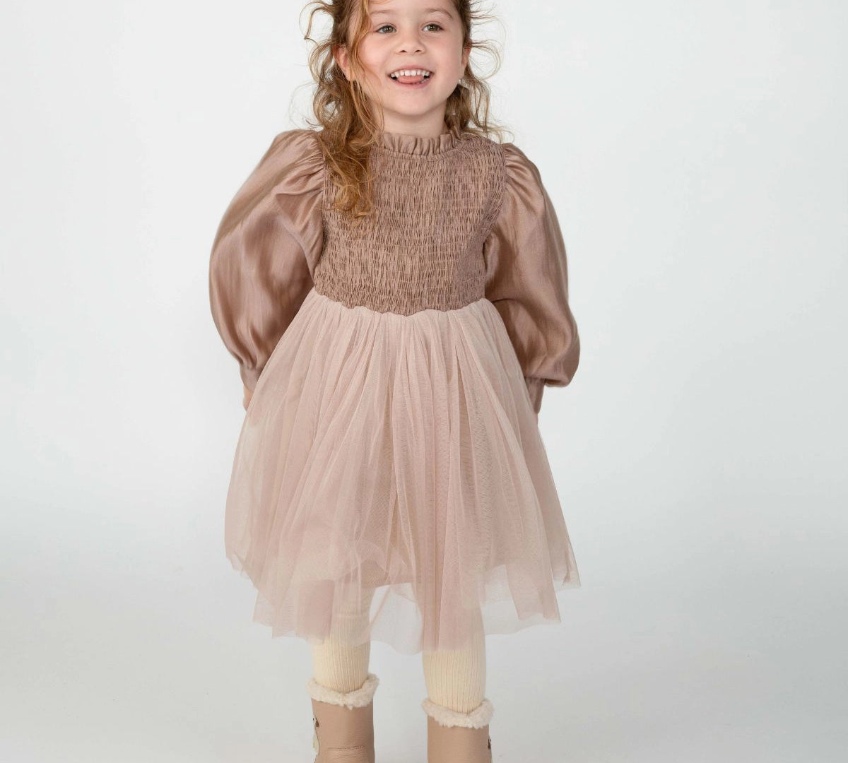 Donsje Janice dress in Rose Brown, worn by a child with beige boots, front view
