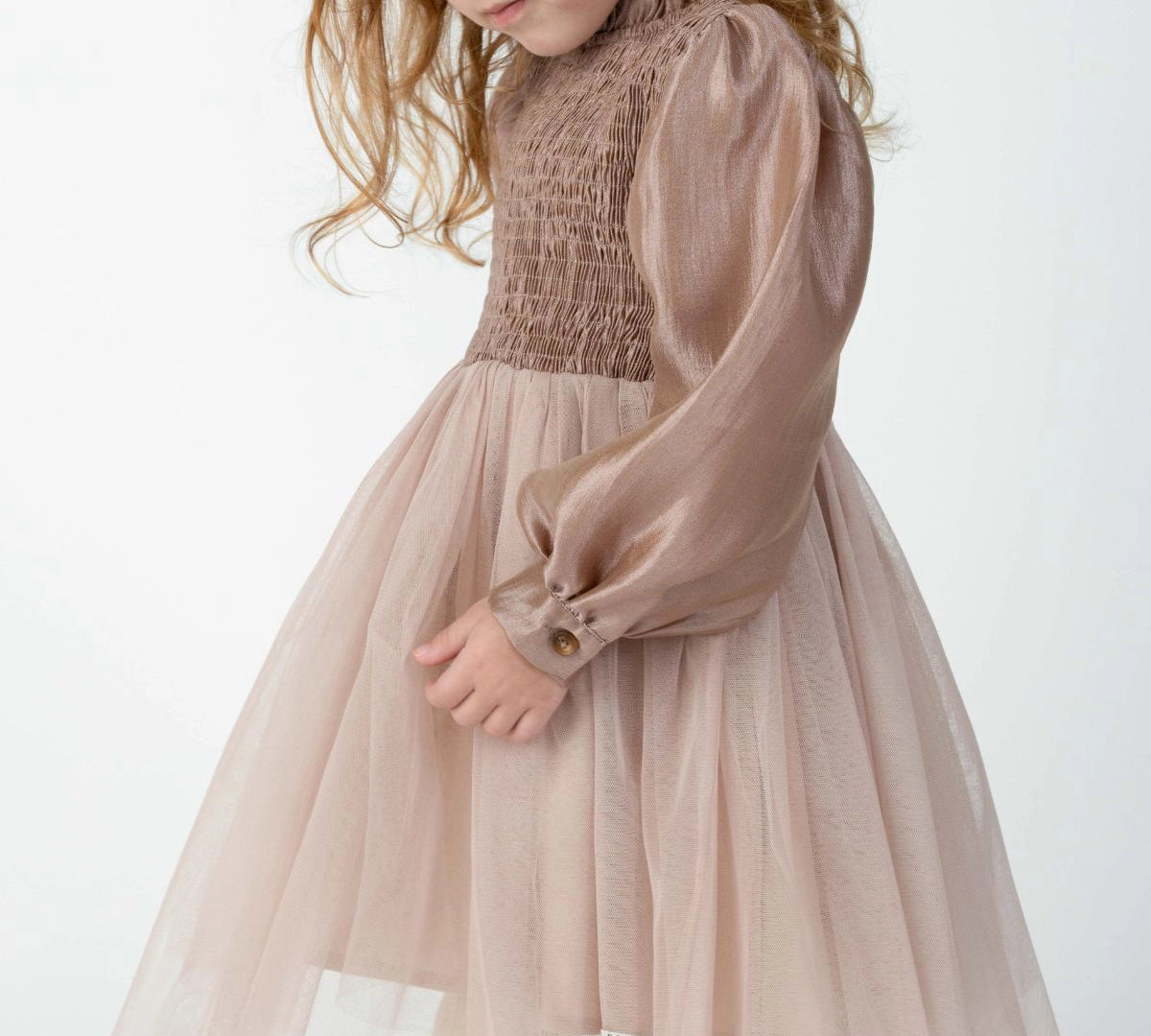 Donsje Janice dress in Rose Brown, worn by a child, angled view