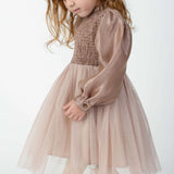 Donsje Janice dress in Rose Brown, worn by a child, angled view