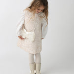 Donsje Lizonne dress in Misty Rose, worn by a child over a white blouse
