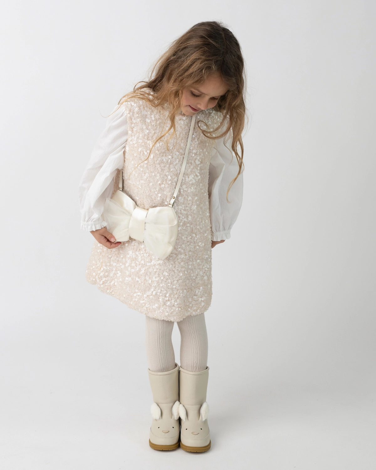 Donsje Lizonne dress in Misty Rose, worn by a child over a white blouse