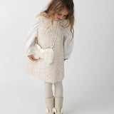 Donsje Lizonne dress in Misty Rose, worn by a child over a white blouse