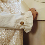 Donsje Lizonne dress in Misty Rose, worn by a child, close-up of the dress