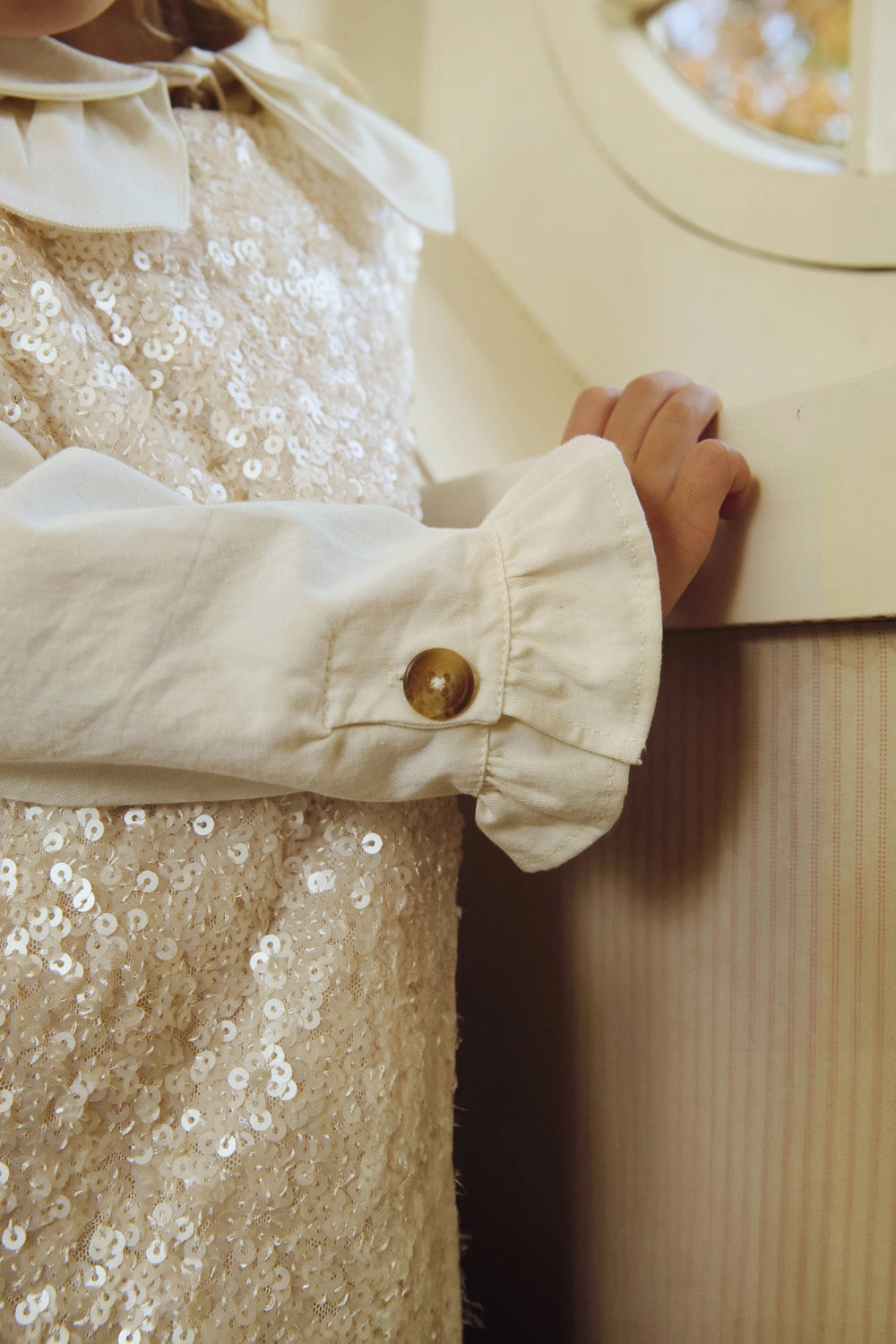 Donsje Lizonne dress in Misty Rose, worn by a child, close-up of the dress