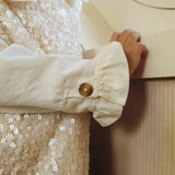Donsje Lizonne dress in Misty Rose, worn by a child, close-up of the dress