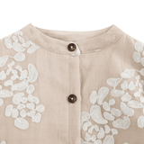 Donsje Opali blouse in Soft Powder with White Blossom, close-up of the neckline and buttons