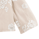 Donsje Opali blouse in Soft Powder with White Blossom, close-up of the floral sleeve and hem