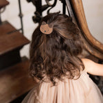 Donsje Pouty Fluffy Bear hairclip in Teddy Brown Suede, worn in a child's hair