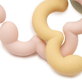 Close-up of the openings in Jollein silicone flower toy loops in pink, yellow and green